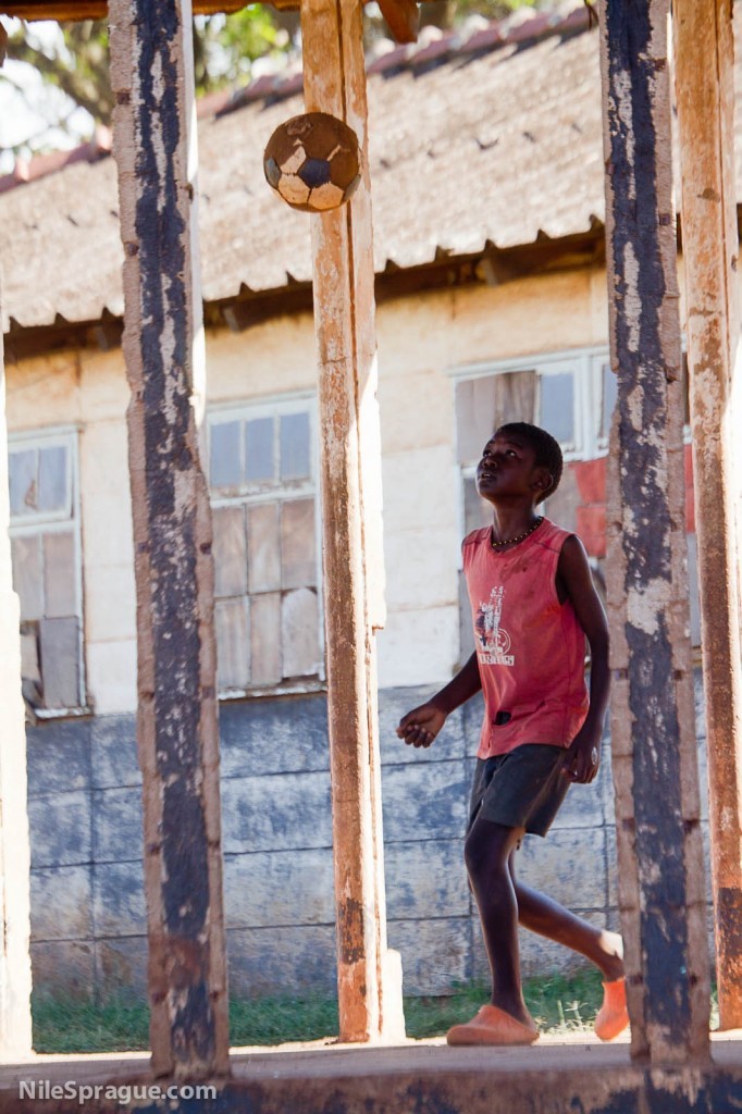 Boy playing with soccer ball, Mathare slum, Nairobi, Kenya.