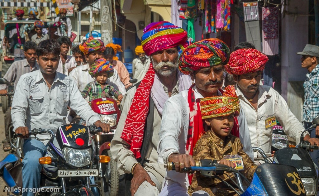 Men and Boys with colorful turbans riding motorcycles, Chau Mahla District, Rajasthan, India.